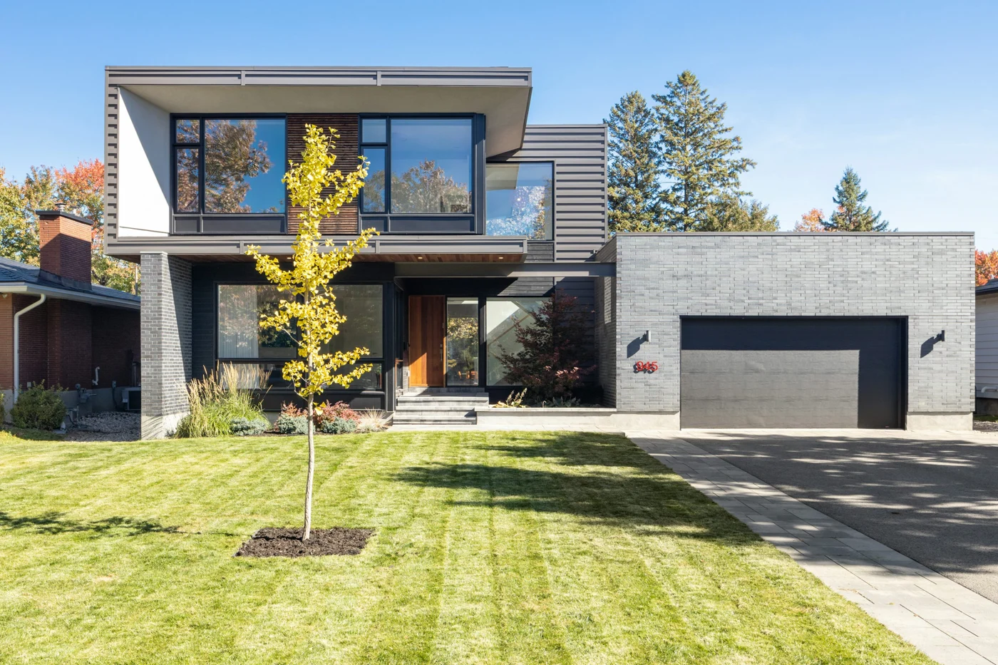 Illustrative stock photograph of a contemporary two-storey home with a landscaped garden